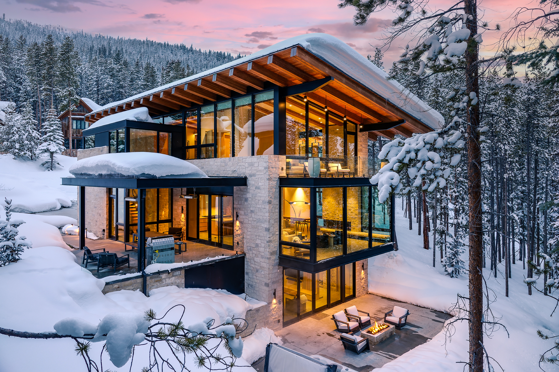 A snow-covered modern mountain home managed by an Awayday local team at winter dusk